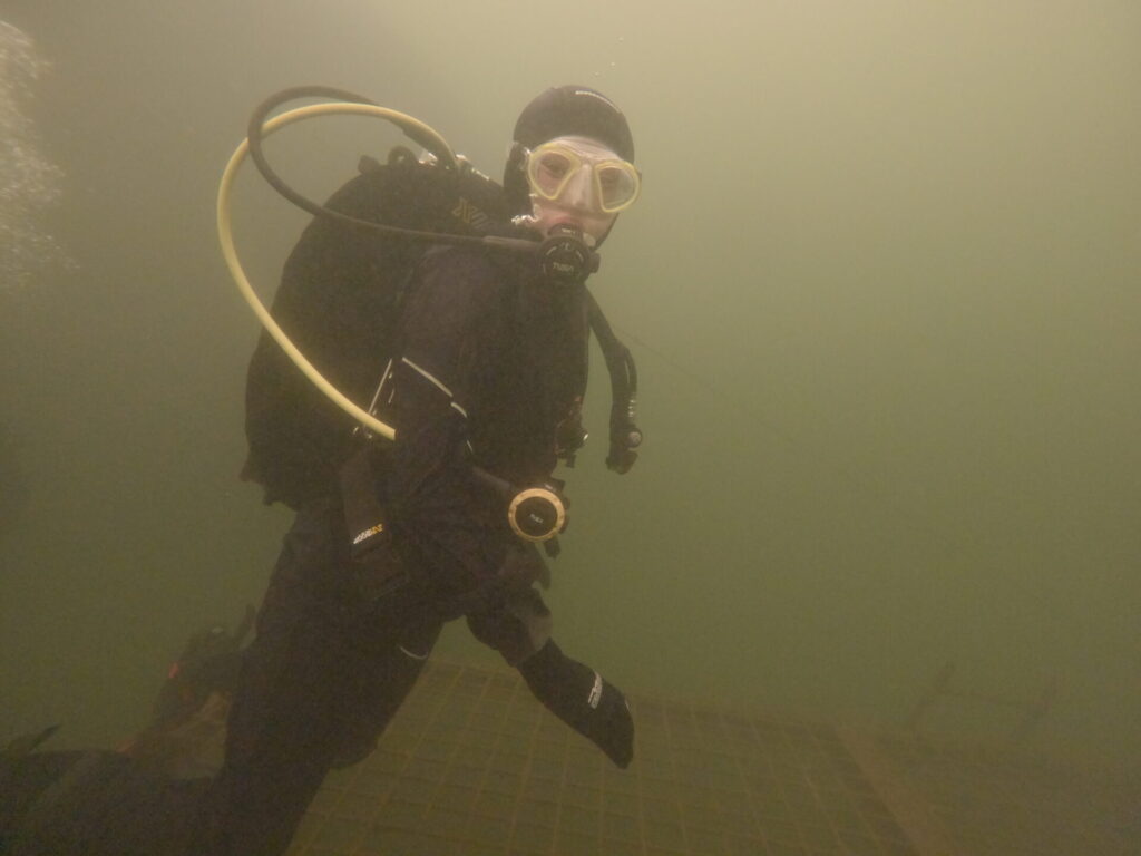 Junior diver in the drysuit doing amazing